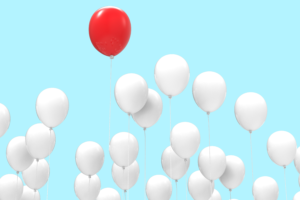 balloons flying, with one differentiated from the rest